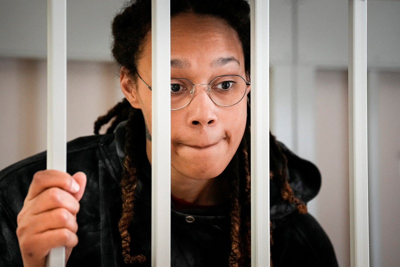 WNBA star and two-time Olympic gold medalist Brittney Griner speaks to her lawyers standing in a cage at a court room prior to a hearing, in Khimki just outside Moscow, Russia, July 26, 2022. Alexander Zemlianichenko/Pool via REUTERS